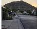 Residential street scene with mature trees and mountain views at sunset at 2233 E Behrend Dr # 84, Phoenix, AZ 85024