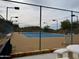 Well-maintained tennis court with net, lighting, and surrounding fence offers recreational opportunities at 2233 E Behrend Dr # 84, Phoenix, AZ 85024