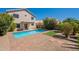 A private backyard pool is surrounded by a brick patio and lush landscaping, perfect for outdoor entertaining at 22420 N 20Th Pl, Phoenix, AZ 85024