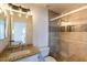 Bathroom offers a granite vanity and tiled walk-in shower with glass doors at 22420 N 20Th Pl, Phoenix, AZ 85024