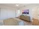 Bright bedroom boasts a TV, dresser, and a view to the bathroom with glass shower door at 22420 N 20Th Pl, Phoenix, AZ 85024