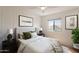 Cozy bedroom boasts neutral decor, a ceiling fan and ample natural light at 22420 N 20Th Pl, Phoenix, AZ 85024