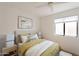 Serene bedroom offers great lighting and neutral decor with gold bedding accents at 22420 N 20Th Pl, Phoenix, AZ 85024