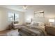Relaxing bedroom featuring a ceiling fan, large window, and neutral decor at 22420 N 20Th Pl, Phoenix, AZ 85024