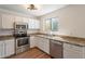 Well-lit kitchen features stainless steel appliances, granite countertops, and ample cabinet space at 22420 N 20Th Pl, Phoenix, AZ 85024