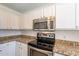 Bright kitchen features granite countertops, stainless steel appliances, and white cabinetry at 22420 N 20Th Pl, Phoenix, AZ 85024