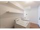 Clean and efficient laundry room with modern washer, dryer and built in shelves provide a space saving design at 22420 N 20Th Pl, Phoenix, AZ 85024