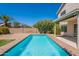 Cool, blue pool surrounded by brick patio and low maintenance landscaping offers a private, backyard retreat at 22420 N 20Th Pl, Phoenix, AZ 85024