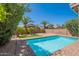 Refreshing pool is surrounded by well maintained landscaping and a brick patio, perfect for outdoor relaxation and enjoyment at 22420 N 20Th Pl, Phoenix, AZ 85024