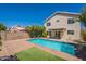 This beautiful pool offers an oasis for relaxation, complemented by a brick patio and a well-maintained yard at 22420 N 20Th Pl, Phoenix, AZ 85024