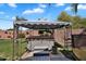 Backyard with a covered hot tub and landscaped garden, all set against a sunny sky at 2412 W Camp River Rd, San Tan Valley, AZ 85144