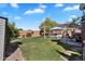 Spacious backyard with green grass, a covered hot tub, an umbrella, and a beautiful blue sky at 2412 W Camp River Rd, San Tan Valley, AZ 85144