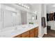 Bright bathroom featuring double sinks with a walk-in closet and toilet shower combo at 2412 W Camp River Rd, San Tan Valley, AZ 85144