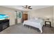 Cozy bedroom with a ceiling fan, nice window and TV on a black console at 2412 W Camp River Rd, San Tan Valley, AZ 85144