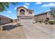 Attractive two-story house with a two-car garage, long driveway, and well-kept low maintenance yard at 2412 W Camp River Rd, San Tan Valley, AZ 85144