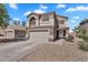 Charming two-story home featuring a two-car garage and low maintenance landscaping with ample parking at 2412 W Camp River Rd, San Tan Valley, AZ 85144