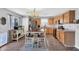 Bright kitchen featuring stainless steel appliances, wood cabinets, and a dining area at 2412 W Camp River Rd, San Tan Valley, AZ 85144