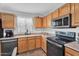 Bright kitchen featuring stainless steel appliances, wood cabinets, and light countertops at 2412 W Camp River Rd, San Tan Valley, AZ 85144