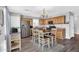 Bright kitchen featuring stainless steel appliances, wood cabinets, and a dining area at 2412 W Camp River Rd, San Tan Valley, AZ 85144