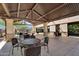 Inviting covered patio with stylish seating, ideal for outdoor dining and entertaining, featuring a mountain view at 2412 W Camp River Rd, San Tan Valley, AZ 85144
