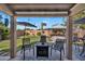 View from covered patio shows seating area, BBQ, hot tub, and a lush lawn on a sunny day at 2412 W Camp River Rd, San Tan Valley, AZ 85144