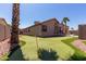 Lush backyard featuring a private putting green, desert landscaping, and a glimpse of the pool, perfect for outdoor enjoyment at 24806 W Hidalgo Dr, Buckeye, AZ 85326