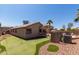 Spacious backyard with a putting green, desert landscaping, and a patio area for relaxing and entertaining outdoors at 24806 W Hidalgo Dr, Buckeye, AZ 85326
