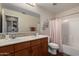 Bathroom featuring double sinks, framed mirrors, a shower and neutral-toned walls at 24806 W Hidalgo Dr, Buckeye, AZ 85326