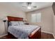 Cozy bedroom boasts wood floors, a ceiling fan, natural light, and an inviting queen bed at 24806 W Hidalgo Dr, Buckeye, AZ 85326