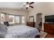 Comfortable bedroom with a ceiling fan and a beautiful window view with natural light at 24806 W Hidalgo Dr, Buckeye, AZ 85326