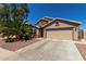 Charming single-Gathering home featuring a desert-style landscape, a two-car garage, and a neutral color palette at 24806 W Hidalgo Dr, Buckeye, AZ 85326