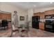 Bright kitchen with a black refrigerator and oven, granite countertops, and dining table with metal chairs at 24806 W Hidalgo Dr, Buckeye, AZ 85326