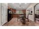 Open-concept kitchen with stainless appliances, granite counters, breakfast nook and access to the living room at 24806 W Hidalgo Dr, Buckeye, AZ 85326