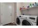 Laundry room with side-by-side washer and dryer and a floating shelf above at 24806 W Hidalgo Dr, Buckeye, AZ 85326