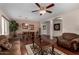 Open-concept living and dining area with hardwood floors, inviting natural light, and stylish furnishings at 24806 W Hidalgo Dr, Buckeye, AZ 85326