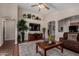 Bright living room boasts built-in shelving, a large TV, and an open layout with hardwood flooring at 24806 W Hidalgo Dr, Buckeye, AZ 85326