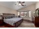Relaxing main bedroom with a large bed, dresser, vaulted ceiling, and a bay window showcasing outside at 24806 W Hidalgo Dr, Buckeye, AZ 85326