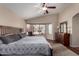 Relaxing main bedroom with a large bed, dresser, vaulted ceiling, and a bay window showcasing outside at 24806 W Hidalgo Dr, Buckeye, AZ 85326
