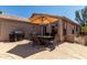Outdoor patio featuring an umbrella, patio table set, and grill at 24806 W Hidalgo Dr, Buckeye, AZ 85326