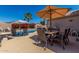 Outdoor patio featuring pool views, a patio umbrella and outdoor dining set at 24806 W Hidalgo Dr, Buckeye, AZ 85326