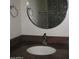 This bathroom features a decorative framed mirror above a granite countertop at 27239 N 64Th Way, Scottsdale, AZ 85266