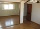 This bedroom has mirrored closet doors, hardwood floors, and a ceiling fan at 27239 N 64Th Way, Scottsdale, AZ 85266