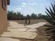 A desert landscape features native plants and decorative gravel with a flagstone walkway at 27239 N 64Th Way, Scottsdale, AZ 85266