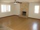 Living room featuring a stone fireplace, ceiling fan, and wood-look flooring at 27239 N 64Th Way, Scottsdale, AZ 85266