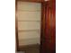 Walk-in pantry features wood trim, a stained wood door, and multiple shelves at 27239 N 64Th Way, Scottsdale, AZ 85266
