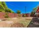 A spacious backyard with a brick fence, young trees and an outdoor shed on a sunny day at 2750 W Turney Ave, Phoenix, AZ 85017