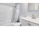 Bathroom with white fixtures, including a shower with a patterned curtain and a matching vanity at 2750 W Turney Ave, Phoenix, AZ 85017
