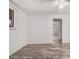 Bright bedroom featuring neutral walls, tile flooring, window with blinds, and an open doorway at 2750 W Turney Ave, Phoenix, AZ 85017
