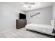 Bedroom with tile floors, window with blinds, TV and dresser, and light gray walls at 2750 W Turney Ave, Phoenix, AZ 85017