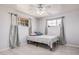 Bright bedroom with two windows, a ceiling fan, and light gray walls and tile flooring at 2750 W Turney Ave, Phoenix, AZ 85017